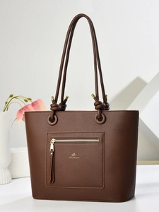 Brown lychee leather tote bag featuring a front zipper pocket with long tassels and gold logo