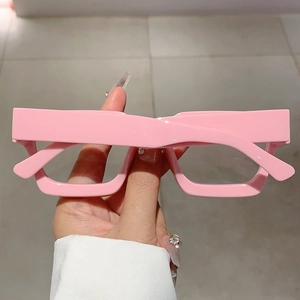 Detail of trendy glossy pink thick rectangular frame glasses with a chic Y2K aesthetic design