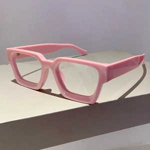 Detail of pink thick frame glasses showing high-gloss finish and retro square shape