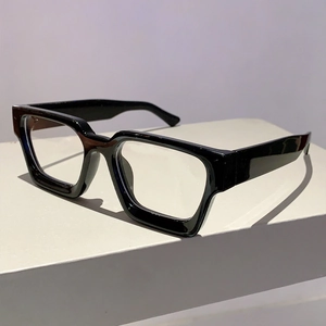 Detail of glossy black thick frame glasses with sturdy geometric square design
