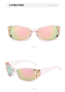 Detail of pink sunglasses with a golden metal butterfly ornament on the side hinge