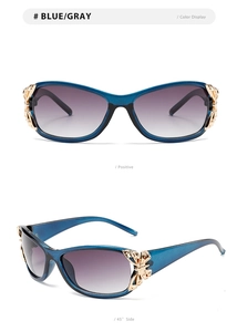 Detail of blue sunglasses with gradient lenses and golden butterfly hinge decoration