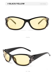 Detail view of stylish sunglasses with metal butterfly decor and yellow lenses