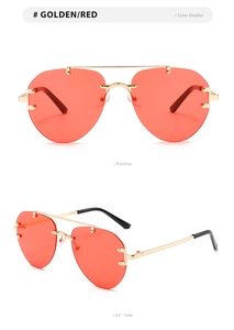 Randlose Aviator-Sonnenbrille mit goldenem Doppelsteg und roten Gläsern in Detailansicht