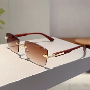 Detail of rimless rectangle sunglasses with brown gradient lenses and wood-style temples