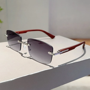Detail of rimless sunglasses featuring wood grain temples and purple gradient lenses
