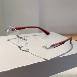 Close-up of rectangular rimless sunglasses with wooden temples and silver metal bridge