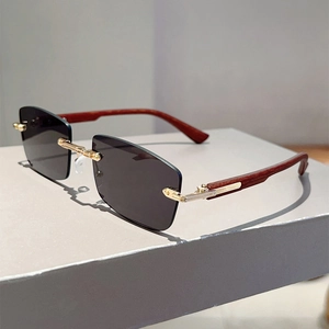 Detail of rimless rectangle sunglasses with gold bridge and wood grain arms