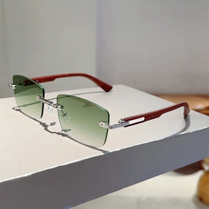 Detail of rimless square sunglasses with wood grain temples and silver metal hinges