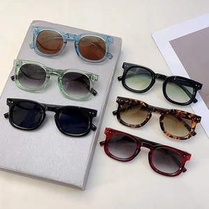 Flat lay of retro square sunglasses in multiple colors with rivet details on frame