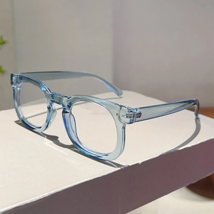 Detail of blue transparent square glasses frames with metal hinges on a white stand
