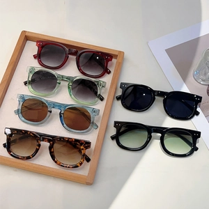 Retro round frame sunglasses with rivet detail in various stylish colors and dark lenses