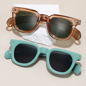 Macro view of vintage thick frame sunglasses with iconic golden arrow metal rivets