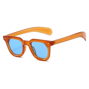 Detail view of vintage orange frame sunglasses with blue lenses and metal rivets