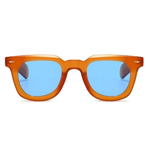 Close-up of retro square orange translucent frames with blue lenses and silver studs