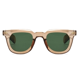 Close-up of retro transparent amber sunglasses frame with golden arrow metal hinge detail