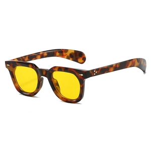 Close-up of retro tortoiseshell sunglasses frames with yellow lenses and metal rivets