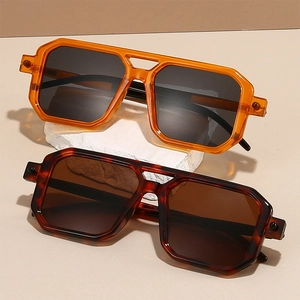 Close-up of retro double-bridge square sunglasses with amber and tortoiseshell frames