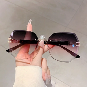 Detail of rimless gradient purple lenses with luxury C-shaped crystal hinge and gold temples