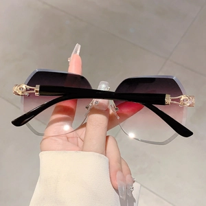 Detail of rimless gradient purple sunglasses with golden metal decorative hinges
