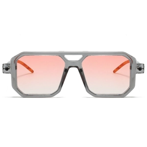 Detail of square sunglasses with transparent grey frame and pink orange gradient lenses