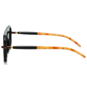Side view of square sunglasses with black frames and tortoise shell temples and gold hinges