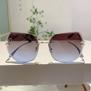 Detail of rimless gradient sunglasses with faceted edges and gold rhinestone accents