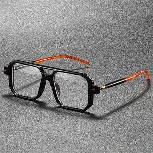 Detail of vintage square glasses with black frames and tortoise shell temples at 45-degree angle