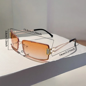 Detail view of square rimless sunglasses with orange gradient lenses and gold metal arms