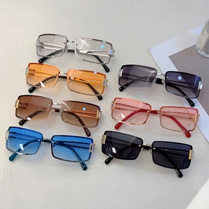 Rectangle rimless sunglasses collection with tinted lenses and gold metal temples