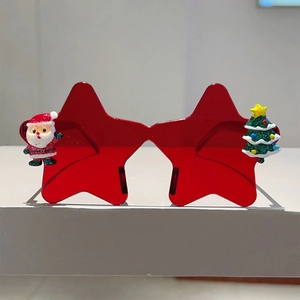 Détail de lunettes de Noël en étoile avec figurine Père Noël et sapin à paillettes