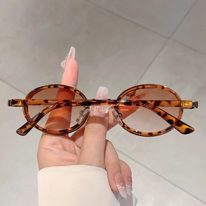 Gros plan de lunettes de soleil ovales rétro avec monture léopard et verres teintés