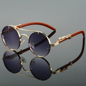 Detail of vintage round sunglasses with gold leopard metal hinge and wood temples