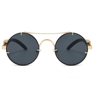 Detailed view of luxury gold metal sunglasses featuring 3D leopard head on the hinge