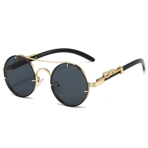 Detail view of retro sunglasses showing gold metal leopard accent and round lens
