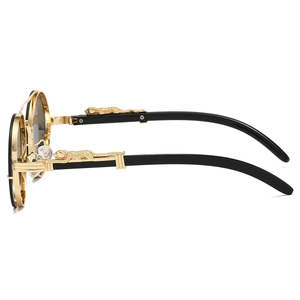 Detail of gold leopard head metal relief on black and gold sunglasses temple