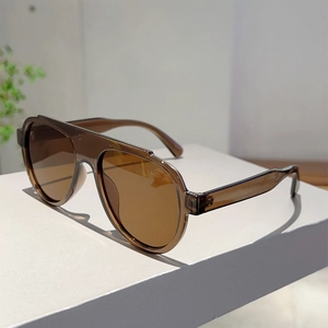 Detail view of oversized pilot sunglasses showing frame specs on brown temple arm