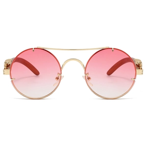 Detailed close-up of golden lion head emblem on wooden temples of retro round sunglasses