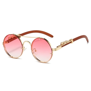 Macro shot of luxury wood temples with golden leopard embellishment on round sunglasses