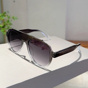 Detail of pilot sunglasses with grey gradient lenses and acetate frame on a podium