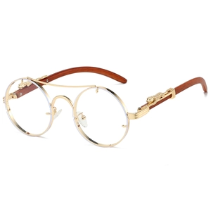 Detail of golden leopard motif on vintage round sunglasses with wooden temples