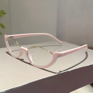 Dettaglio occhiali cat-eye rosa con bordo in metallo dorato e montatura in acetato