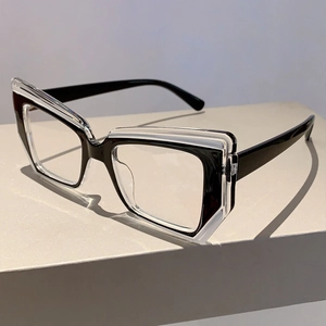 Detail of geometric cat-eye glasses frame with black and transparent layered material