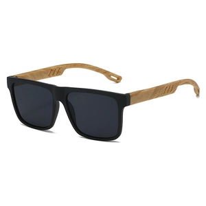 Close-up of matte black sunglasses featuring light wood grain temples and dark gray lenses