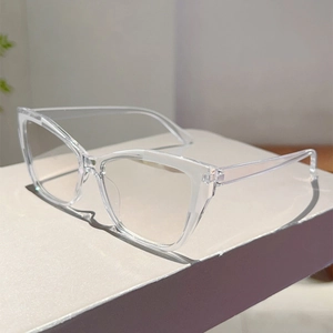 Detail view of transparent cat-eye glasses frames with a modern minimalist aesthetic