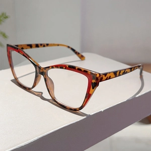 Detail shot of cat eye glasses frame with classic tortoiseshell and red color block design