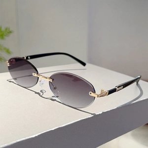 Detail of rimless oval sunglasses with purple gradient lenses and gold metal hinges