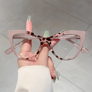 Pink and leopard print cat eye glasses frames held by hand for a stylish eyewear look
