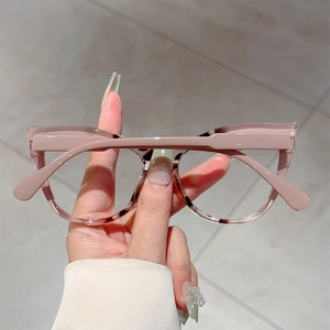 Detail of light pink oversized cat-eye glasses frame made of premium acetate material