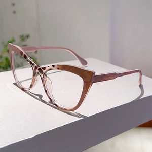 Detailed side view of cat-eye frames featuring brown tortoise and pink translucent finish